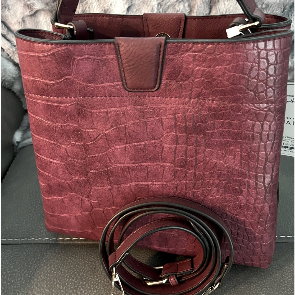 Plum colored Jen & Co purse with crossbody strap.